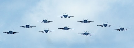 Aircraft attached to Carrier Air Wing 5 fly in formation near the U.S. Navy’s only forward-deployed aircraft carrier, USS Ronald Reagan (CVN 76), during air combat-skills practice in the Pacific Ocean.