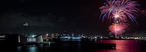 Fireworks from a Fourth of July celebration illuminate the night sky over Joint Base Pearl Harbor-Hickam and the USS Arizona Memorial during Exercise Rim of the Pacific (RIMPAC) 2024.