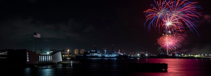 Fireworks from a Fourth of July celebration illuminate the night sky over Joint Base Pearl Harbor-Hickam and the USS Arizona Memorial during Exercise Rim of the Pacific (RIMPAC) 2024.