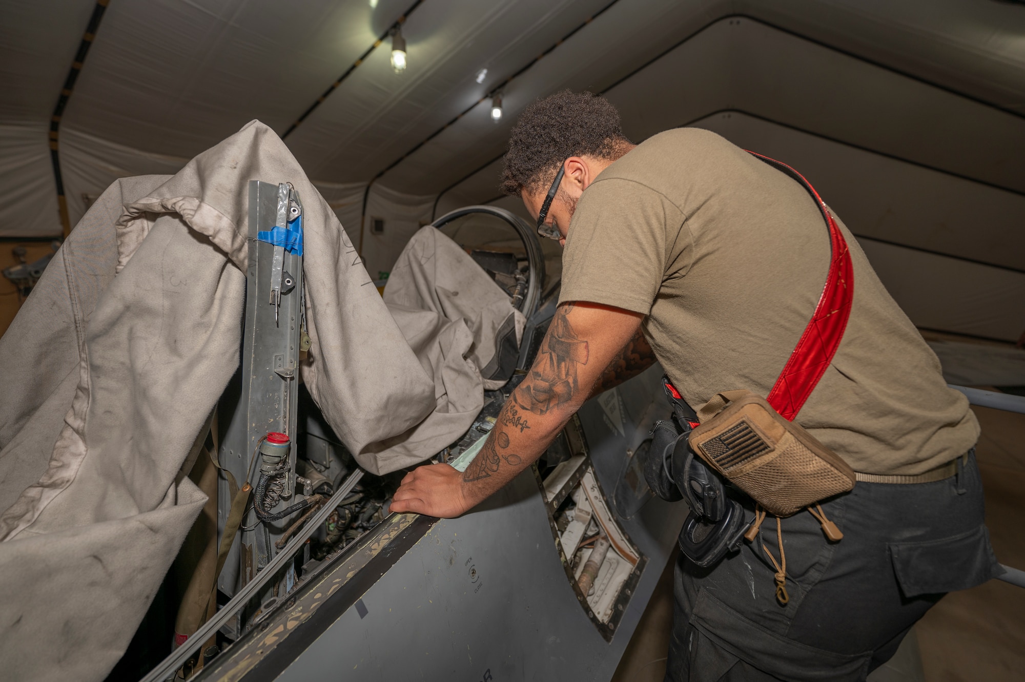 A U.S. Air Force maintainer assigned to the 378th Expeditionary Maintenance Squadron repairs a F-16 Fighting Falcon at an undisclosed location within the U.S. Central Command area of responsibility, June 24, 2024. To maximize combat capability, the EMXS gained engineer approval to repair the aircraft on site, installing twenty-six components in four days to restore the aircraft’s structural integrity.(U.S. Air Force photo)