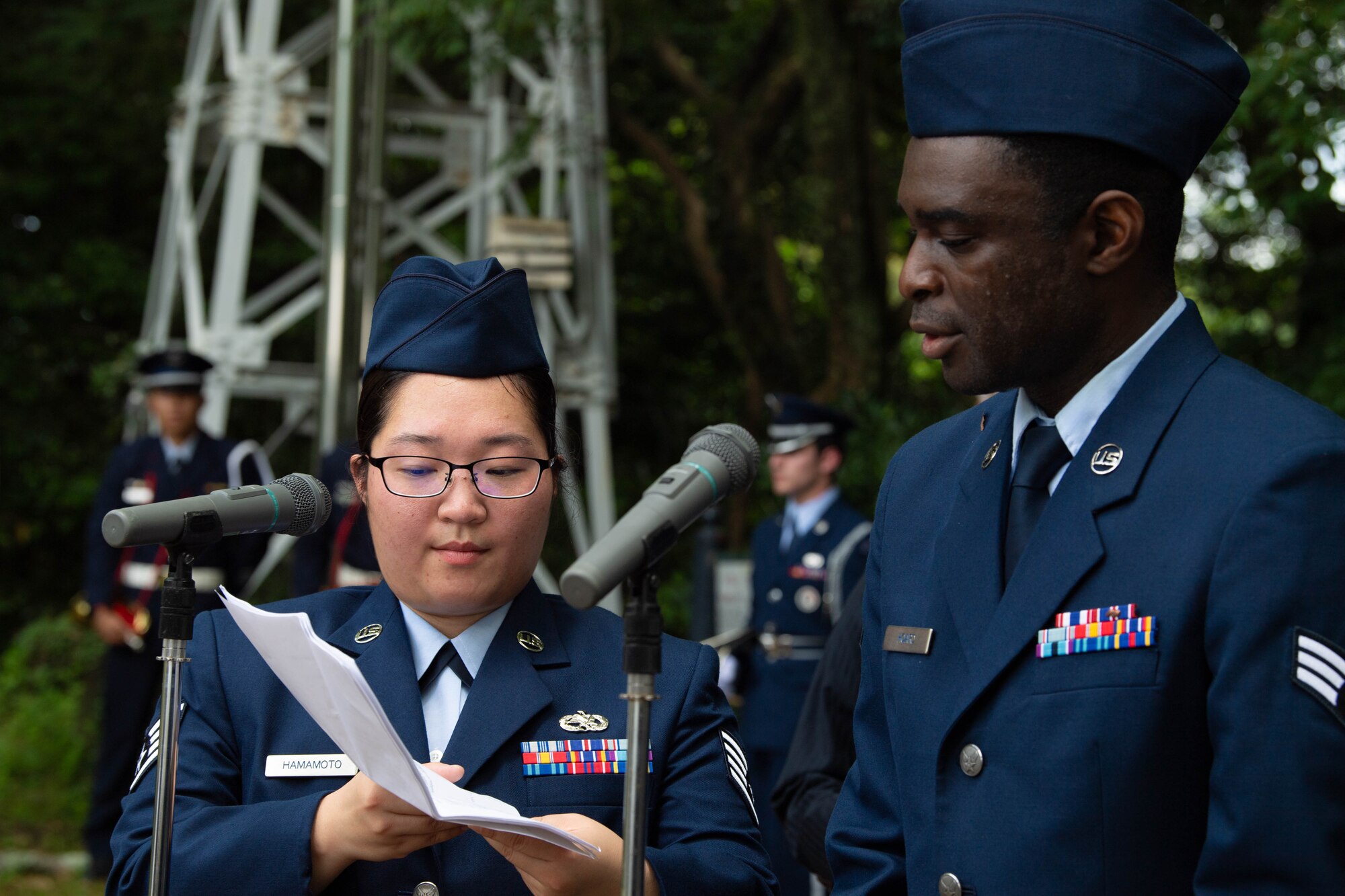 Two Airmen read from a paper.