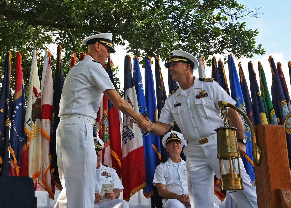 DIEGO GARCIA, British Indian Ocean Territory—Capt. Nathan W. Fugate, left, relinquishes command of Maritime Prepositioning Ships Squadron Two to Capt. Aaron L. Helgerson during a ceremony at headquarters, U.S. Navy Support Facility Diego Garcia, June 10, 2024. (Navy photo by Ensign Jayme Gordon)