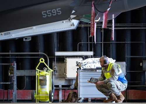Weapons safety member performs an inspection during a weapons load.