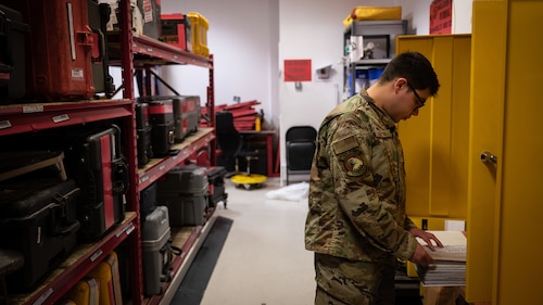 Occupational safety member conducts safety checks on hazard communication lockers.