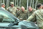 U.S. Army Chief Warrant Officer 2 Ted Schroeder, 507th Engineer Battalion, project officer in charge, discusses the potential wet-gap training area with Latvian Armed Forces leadership during the design phase of the Selija Military Training Area in Latvia, June 5, 2024. Michigan Army National Guard Army Corp of Engineers will collaborate with Latvian Zemessardze Engineers over the next several years, contributing to the Selonia Training Area at each development phase.