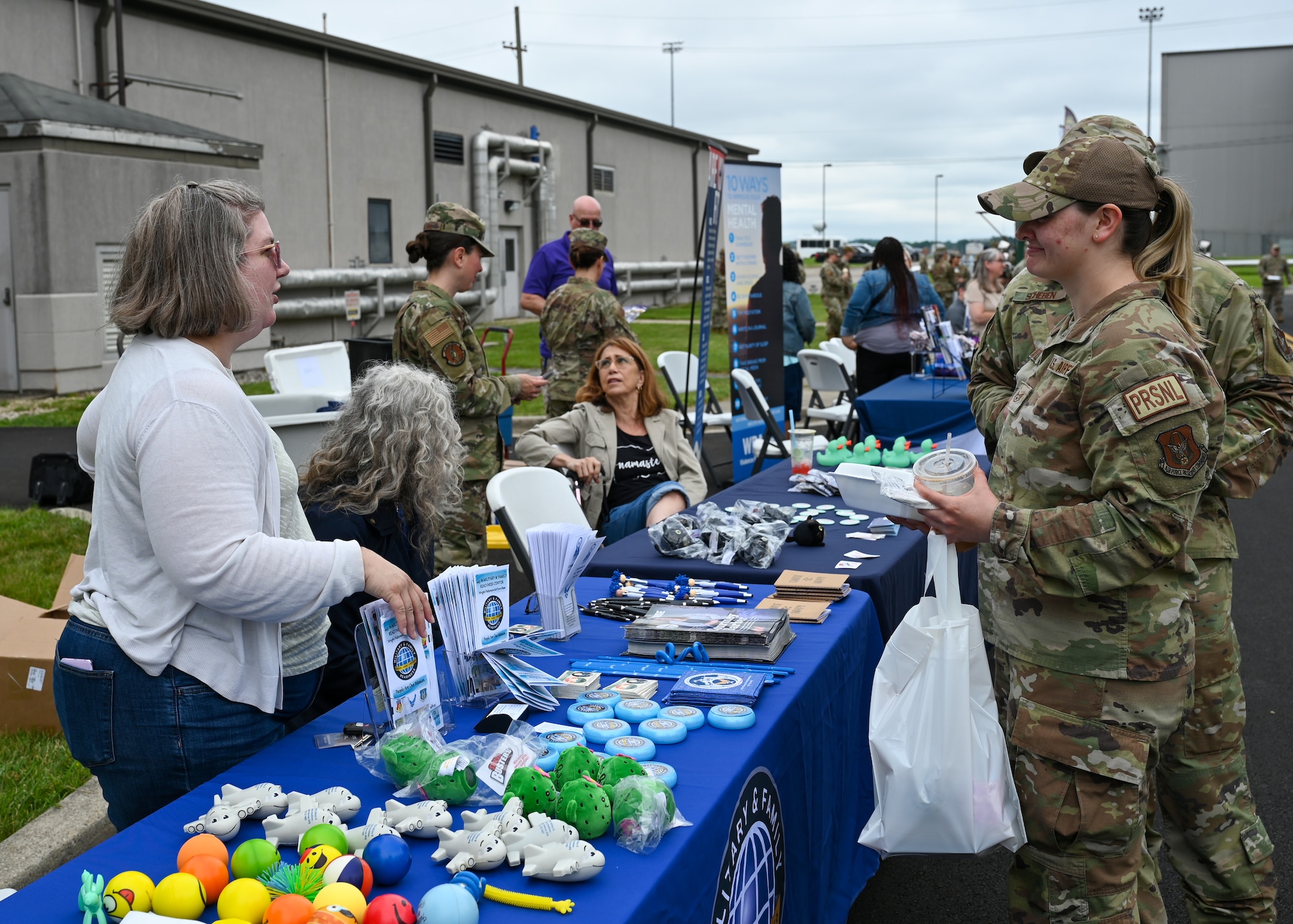Shanna King, left, 445th Force Support Squadron Military and Family Readiness director, speaks to 445th Airlift Wing Airmen about available programs and services during the Annual 445th Wellness Fair at Wright-Patterson Air Force Base, Ohio, June 2, 2024. The wellness fair featured information provided by Veterans Affairs, Wounded Warriors, Military One Source, 4Paws for Ability, and 445th Airlift Wing and 88th Air Base Wing helping agencies.