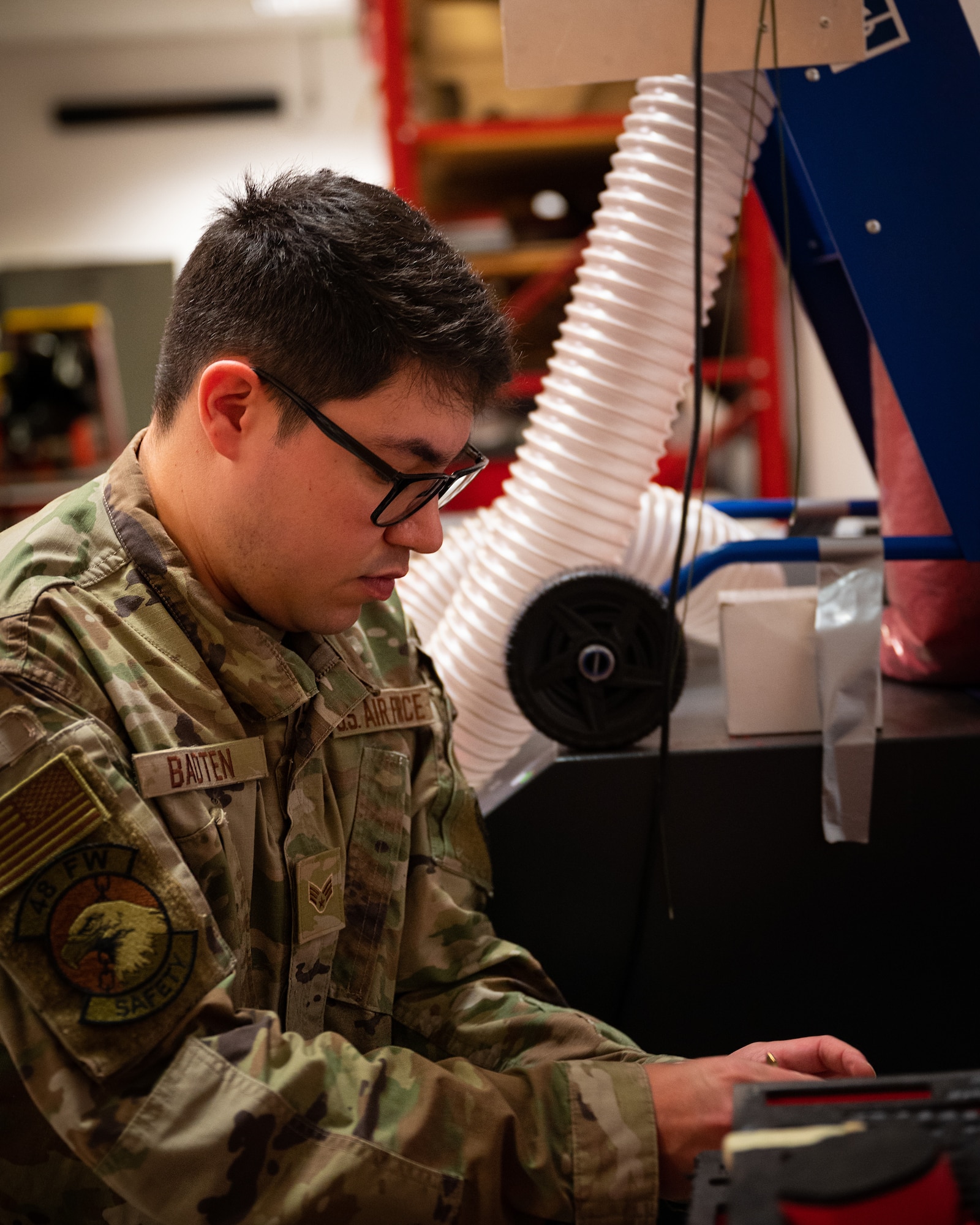 Occupational safety member conducts a safety check on equipment.