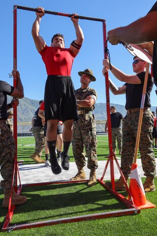 U.S. Marine Corps Sgt. Steven Nguyen, a drill instructor with Marine Corps Recruit Depot San Diego, counts pull-ups for a poolee during the Recruiting Station Riverside annual pool function at Los Osos High School in Ranchero Cucamonga, Calif., June 22, 2024. Pool functions are held to build camaraderie and heathy competition while preparing poolees for the mental and physical rigors of recruit training. (U.S. Marine Corps photo by Sgt. Cutler Brice)