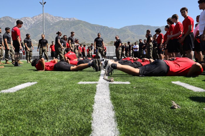 U.S. Marine Corps poolees with Recruiting Station Riverside, 12th Marine Corps District, prepare for a tug-of-war competition during the RS Riverside annual pool function at Los Osos High School in Ranchero Cucamonga, Calif., June 22, 2024. Pool functions are held to build camaraderie and heathy competition while preparing poolees for the mental and physical rigors of recruit training. (U.S. Marine Corps photo by Sgt. Cutler Brice)