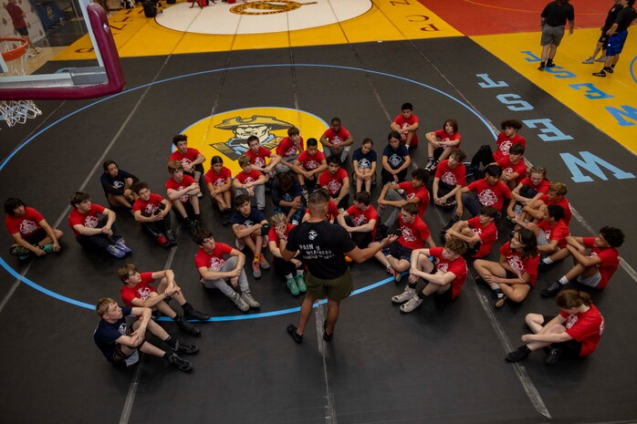 U.S. Marine Corps Staff Sgt. Romeo Rojo, the station commander of Recruiting Sub-Station Oklahoma City North, Recruiting Station Oklahoma City, 9th Marine Corps District, conducts a leadership talk during the United States Marine Corps Sports Leadership Academy (USMC SLA) Wrestling Camp at Putnam City North High School, Oklahoma City, Okla., June 1, 2024. The USMC SLA is an organization designed to teach athletes the fundamentals of Marine Corps leadership techniques and skills through different sports to help them in their high school athletic careers. (U.S. Marine Corps photo by Sgt. Lennon Dregoiw)