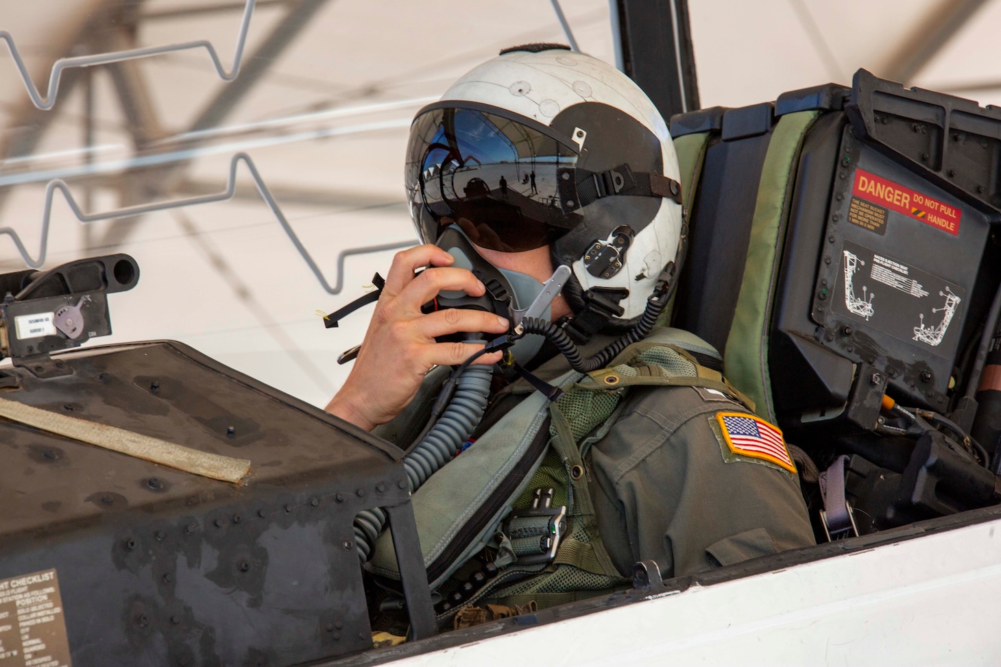 EL CENTRO, Calif. (July 19, 2023) Lt. Jacob Cummins, assigned to the El Centro strike training detachment, dons an oxygen mask in a T-45C Goshawk jet aircraft on the flight line onboard Naval Air Facility (NAF) El Centro, Calif. July 19, 2023. NAF El Centro supports combat training and readiness of the Warfighter. This includes air operations support to operational fleet and training squadrons as well as squadrons from other services (USMC, USA, USAF) and Allies. (U.S. Navy photo by Mass Communication Specialist 3rd Class Aleksandr Freutel)