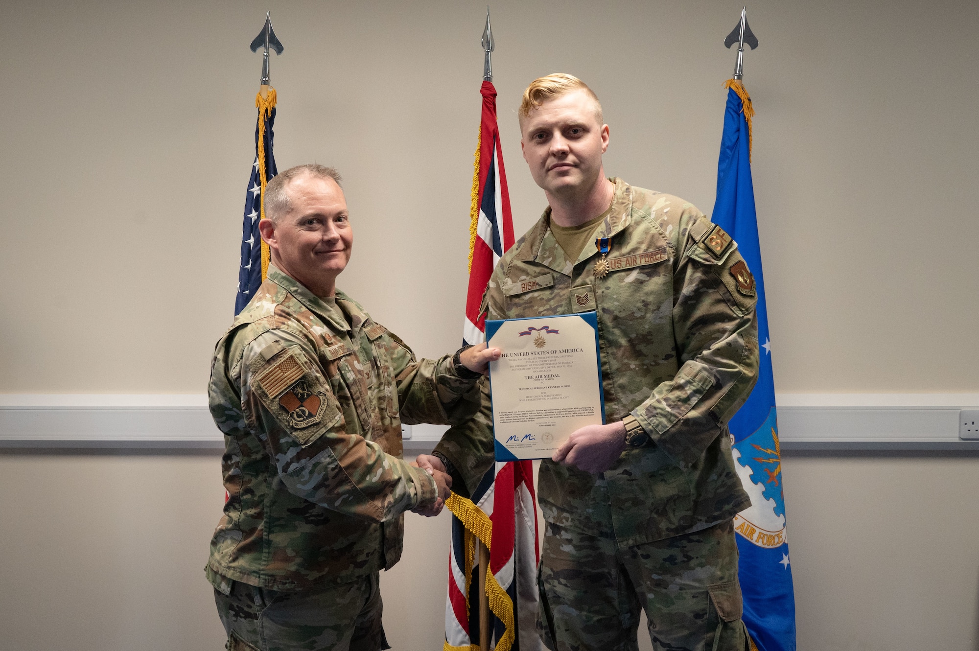 Airmen pose for a photo during a recognition ceremony