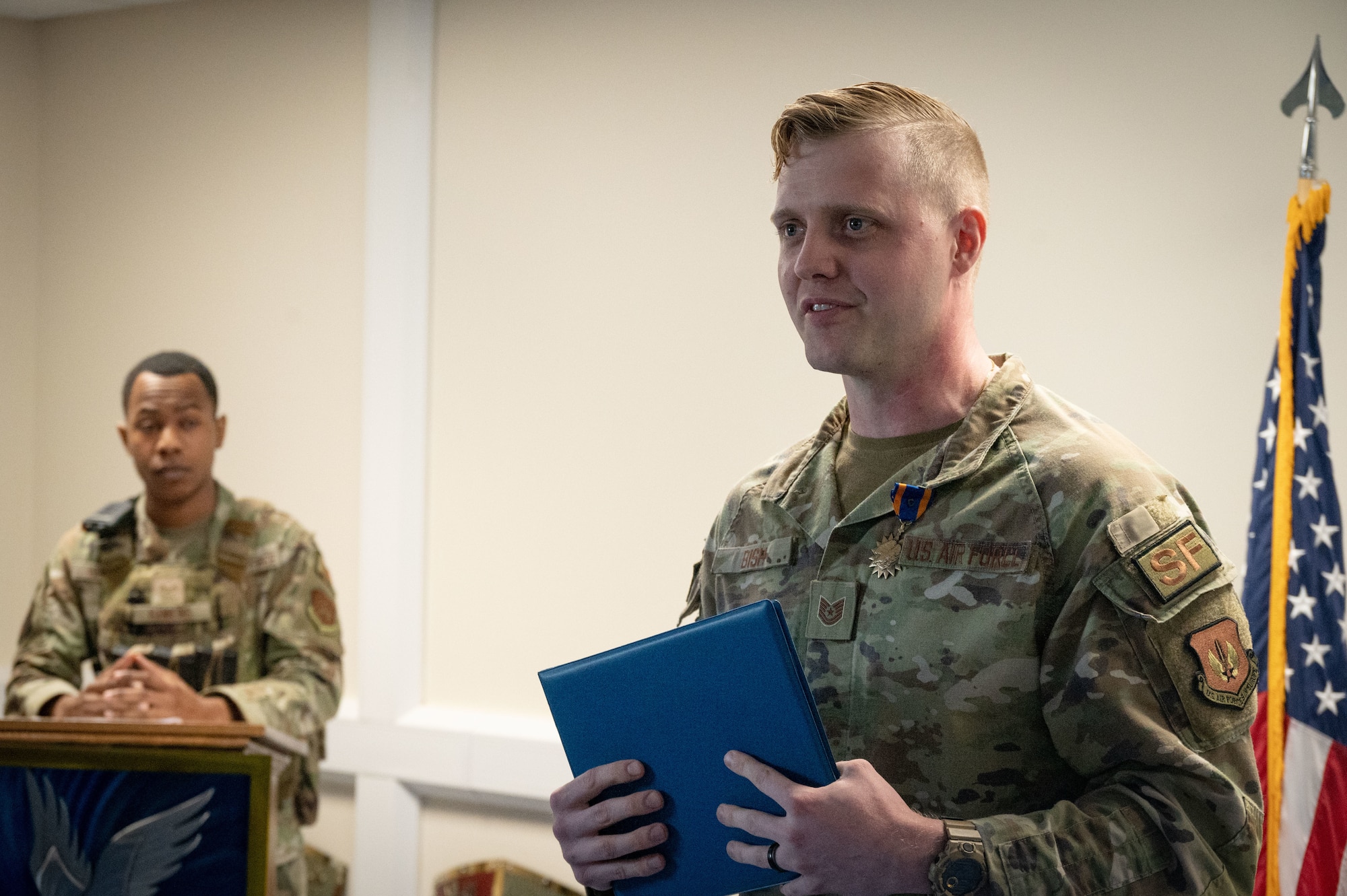 An Airman speaks during a recognition ceremony