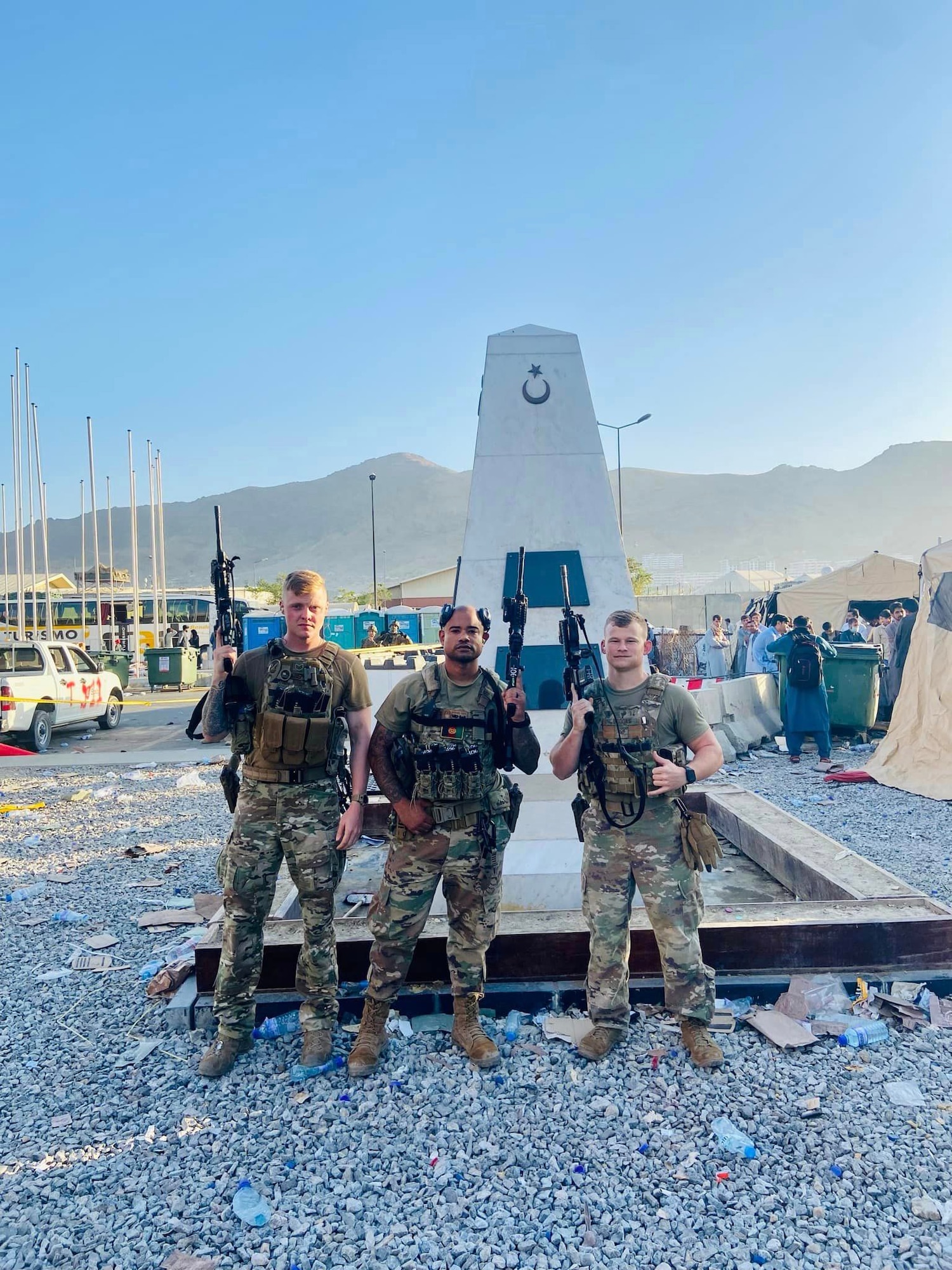 Defenders pose for a group photo outside of Hamid Karzai International Airport