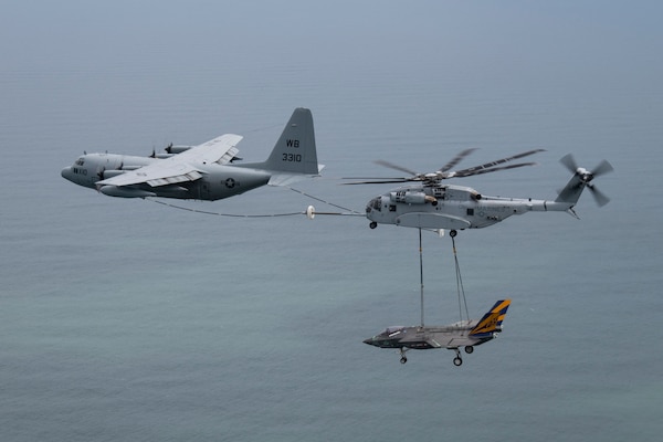 U.S. Marines from VMX-1 piloting a CH-53K helicopter conduct aerial refueling from a C-130T operated by U.S. Navy’s VX-20 while carrying a non-flying F-35C test airframe from the NAS Patuxent River F-35 Integrated Test Force on April 24, 2024. The flight was conducted to transport the non-flying airframe from NAS Patuxent River, MD, to Joint Base McGuire-Dix-Lakehurst, NJ, where it will be used in future emergency recovery systems testing.