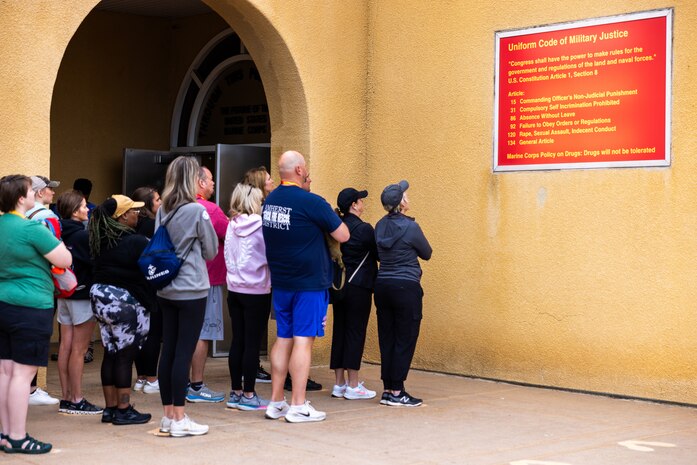 Educators with Recruiting Stations’ Milwaukee, Oklahoma City, and Twin Cities stand on the yellow footprints during a mock receiving event as a part of the 2024 Educators’ Workshop at Marine Corps Recruit Depot San Diego, Calif., June 18, 2024. Participants visited MCRD San Diego to observe recruit training and gain a better understanding about the transformation from recruits to United States Marines. The educators also received classes and briefs on the benefits that are provided to service members serving in the U.S. Armed Forces. (U.S. Marine Corps photo by Cpl. Maxwell Cook)