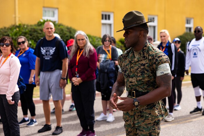 U.S. Marine Corps Staff Sgt. Devon Greene, a drill instructor with Alpha Company, 1st Recruit Training Battalion, explains drill movements to educators from Recruiting Stations’ Milwaukee, Oklahoma City, and Twin Cities during the 2024 Educators’ Workshop at Marine Corps Recruit Depot San Diego, Calif., June 18, 2024. Participants visited MCRD San Diego to observe recruit training and gain a better understanding about the transformation from recruits to United States Marines. The educators also received classes and briefs on the benefits that are provided to service members serving in the U.S. Armed Forces. (U.S. Marine Corps photo by Cpl. Maxwell Cook)