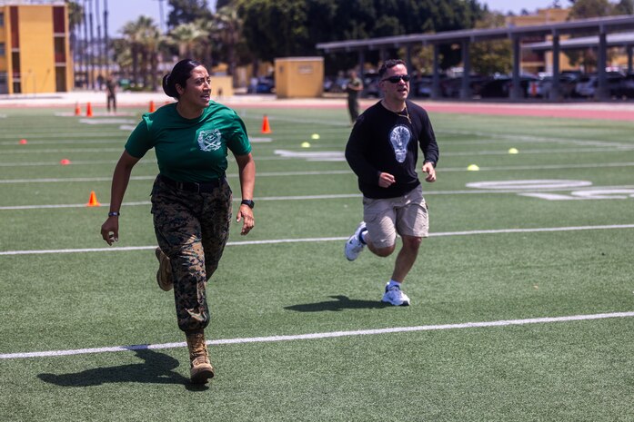 U.S. Marine Corps Staff Sgt. Fabiola Alexander, a drill instructor with Support Training Company, Support Battalion, motivates an educator from 9th Marine Corps District during the maneuver under fire portion of the combat fitness test as a part of the 2024 Educators’ Workshop at Marine Corps Recruit Depot San Diego, Calif., June 18, 2024. Educators with Recruiting Stations’ Milwaukee, Oklahoma City, and Twin Cities visited MCRD San Diego to observe recruit training and gain a better understanding about the transformation from recruits to United States Marines. The educators also received classes and briefs on the benefits that are provided to service members serving in the U.S. Armed Forces. (U.S. Marine Corps photo by Cpl. Maxwell Cook)