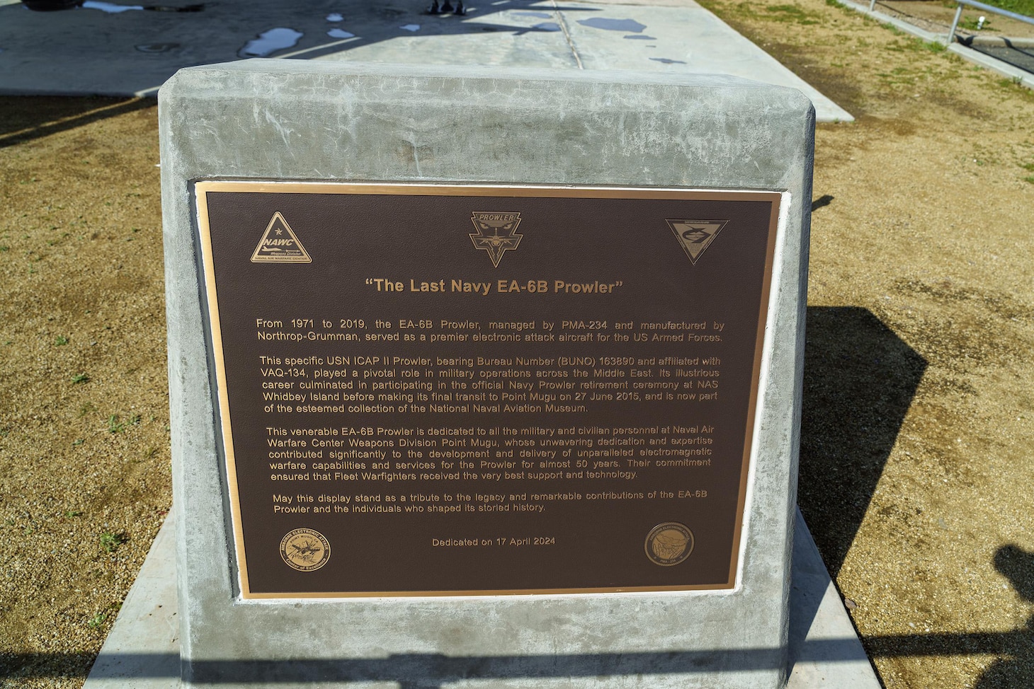 A bronze plaque commemorating the EA-6B Prowler is unveiled during a dedication ceremony at Missile Park at Point Mugu, California, April 17, 2024. The plaque honors the Prowler's service from 1971 to 2019 as the U.S. Navy and Marine Corps' premier electronic attack aircraft.