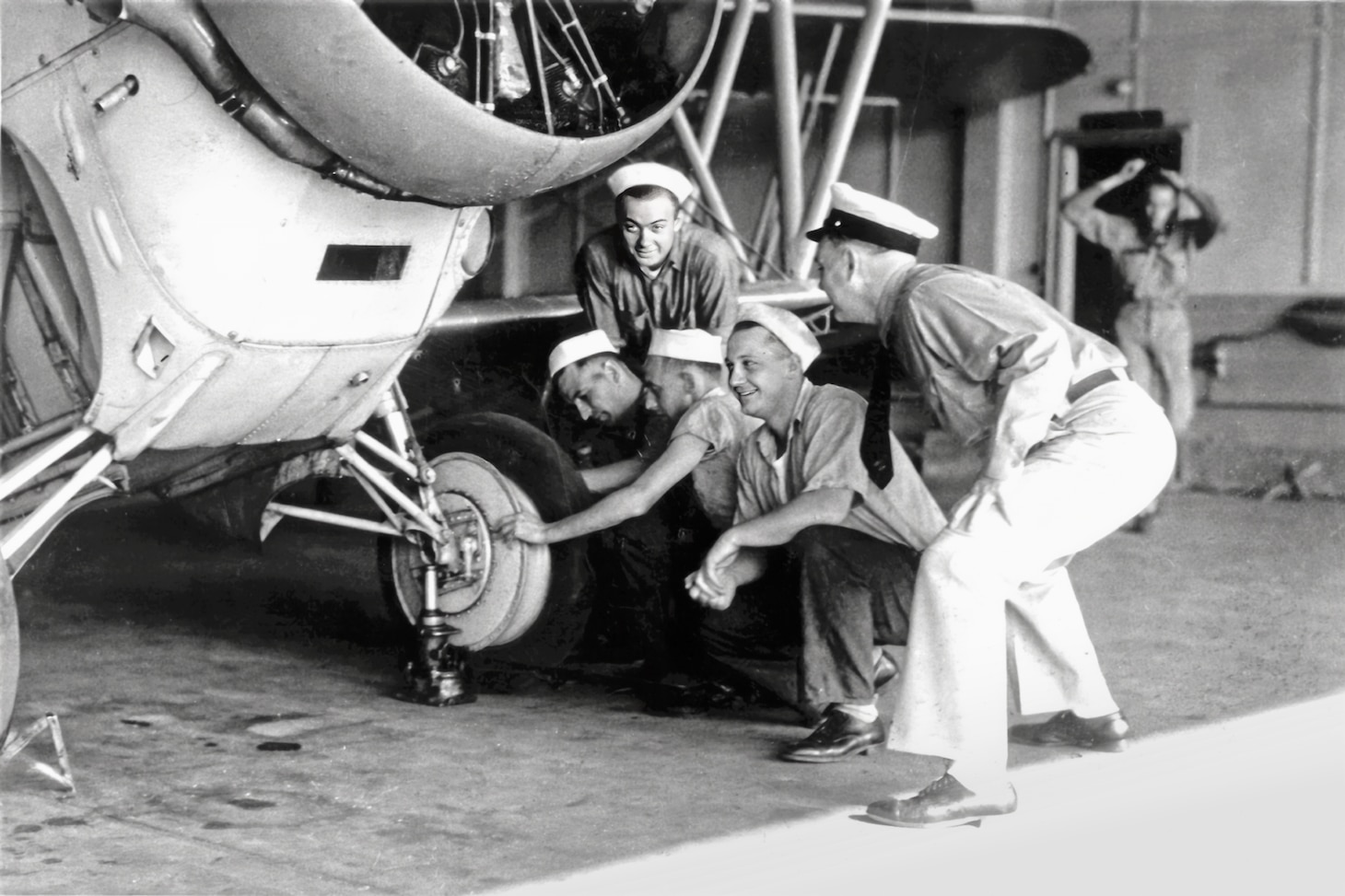 Minneapolis Naval Air Reservists check their Grumman SF-1’s retractable landing gear, a real novelty in the mid-1930s. During the pre-WWII decade, Grumman produced several one- and two-seat aircraft based on the same general design. The SF-1 was a two-seat scout, several of which were attached to the USS Lexington (CV-2) before the war. It was armed with one forward-firing .30 caliber machine gun, while the observer in the rear seat had two .30 caliber machine guns by mid-war. Retractable landing gear remained both a novelty as well as a problem especially for flight crews to remember before landing.