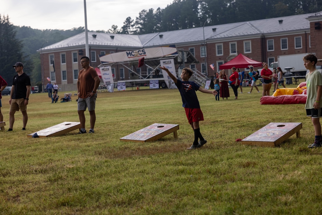 Attendees play cornhole during the annual Marine Corps Base Quantico Independence Day Celebration at Lejeune Field on MCBQ, Virginia, July 4, 2024. The event included family friendly games, food trucks and vendors, and culminated with a firework show. (U.S. Marine Corps photo by Cpl. Keegan Bailey)