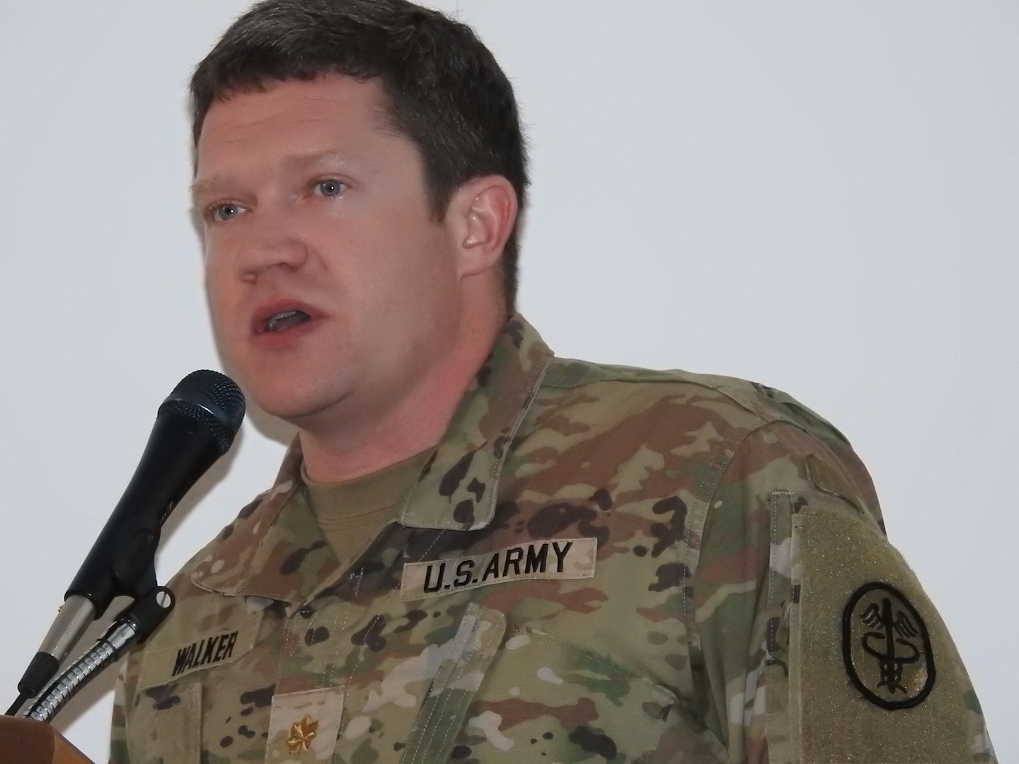 Army Maj. (Dr.) Patrick Walker, a trauma surgeon at Walter Reed, discusses research concerning the clinical needs in cancer care and battlefield medicine during the John P. Murtha Cancer Center Annual Cancer Summit on June 26 at Walter Reed National Military Medical Center.