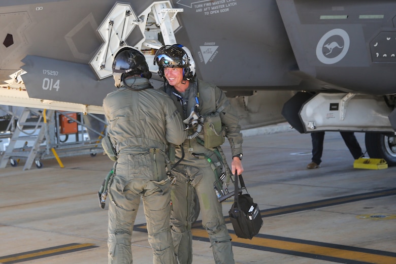 U.S. Marine Corps Maj. John Rose, right, an F-35B Lightning II pilot and executive officer of Marine Fighter Attack Squadron (VMFA) 214, Marine Aircraft Group 13, 3rd Marine Aircraft Wing, and Royal Australian Air Force Flight Lieutenant  Nicholas Ebzery, an F-35A pilot with the RAAF No. 75 Squadron, celebrate after a flight at RAAF Base Tindal, Northern Territory, Australia, June 13, 2024. Leaders with VMFA-214, a USMC F-35B squadron, flew the RAAF F-35A during bilateral training, exhibiting interchangeability between RAAF and U.S. Marine aviation. VMFA-214 deployed more than 200 Marines and eight F-35B Lightning II aircraft from Marine Corps Air Station Yuma, Arizona, to RAAF Base Tindal, Australia, to conduct bilateral training with the RAAF No. 3 Squadron and No. 75 Squadron. (U.S. Marine Corps photo by Cpl. Nicholas Johnson)