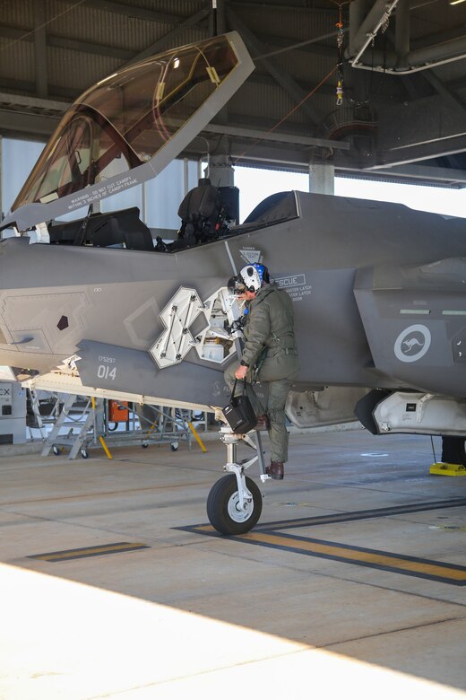 U.S. Marine Corps Maj. John Rose, an F-35B Lightning II pilot and the executive officer of Marine Fighter Attack Squadron (VMFA) 214, Marine Aircraft Group 13, 3rd Marine Aircraft Wing, debarks from a Royal Australian Air Force F-35A Lightning II aircraft assigned to the RAAF No. 75 Squadron at RAAF Base Tindal, Northern Territory, Australia, June 13, 2024. Leaders with VMFA-214, a USMC F-35B squadron, flew the RAAF F-35A during bilateral training, exhibiting interchangeability between RAAF and U.S. Marine aviation. VMFA-214 deployed more than 200 Marines and eight F-35B Lightning II aircraft from Marine Corps Air Station Yuma, Arizona, to RAAF Base Tindal, Australia, to conduct bilateral training with the RAAF No. 3 Squadron and No. 75 Squadron. (U.S. Marine Corps photo by Cpl. Nicholas Johnson)
