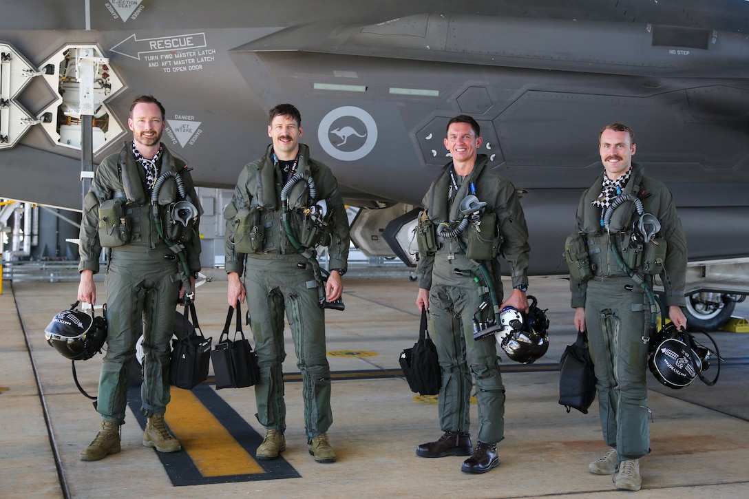 From left, Royal Australian Air Force Flight Lieutenant Stuart Atkin, an F-35A Lightning II pilot with the RAAF No. 75 Squadron; RAAF Squadron Leader Brett Gordon, an F-35A Lightning II pilot with the RAAF No. 75 Squadron; U.S. Marine Corps Maj. John Rose, an F-35B Lightning II pilot and executive officer of Marine Fighter Attack Squadron (VMFA) 214, Marine Aircraft Group 13, 3rd Marine Aircraft Wing; and RAAF Flight Lieutenant Nicholas Ebzery, an F-35A Lightning II pilot with the RAAF No. 75 Squadron, pose for a picture after a flight at RAAF Base Tindal, Northern Territory, Australia, June 13, 2024. Leaders with VMFA-214, a USMC F-35B squadron, flew the RAAF F-35A during bilateral training, exhibiting interchangeability between RAAF and U.S. Marine aviation. VMFA-214 deployed more than 200 Marines and eight F-35B Lightning II aircraft from Marine Corps Air Station Yuma, Arizona, to RAAF Base Tindal, Australia, to conduct bilateral training with the RAAF No. 3 Squadron and No. 75 Squadron. (U.S. Marine Corps photo by Cpl. Nicholas Johnson)