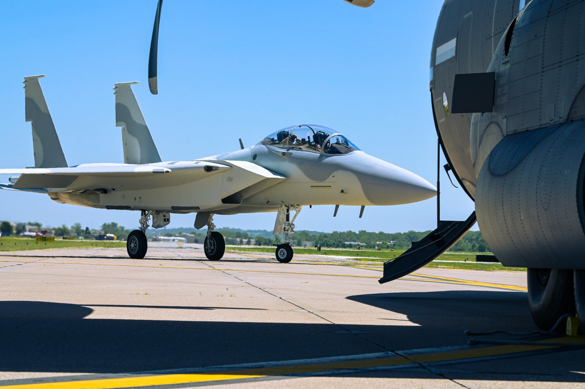 An F-15 QA taxis past an MC-130J Commando II during the Spirit of St. Louis Air Show at St. Louis Lambert International Airport, Missouri, June 8, 2024.