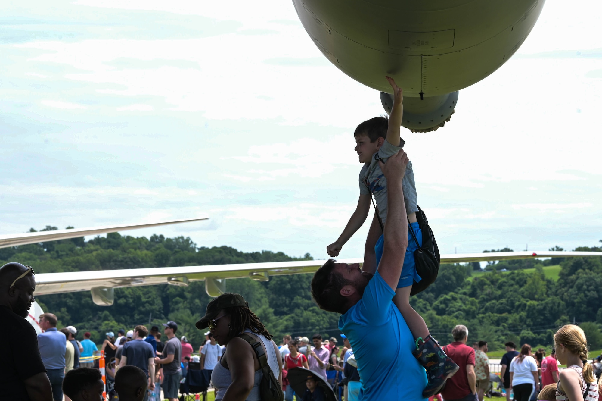 A spectator of the Spirit of St. Louis Air Show lifts their child to touch an MC-130J Commando II, assigned to the 15th Special Operations Squadron, at St. Louis Lambert International Airport, Missouri, June 9, 2024.