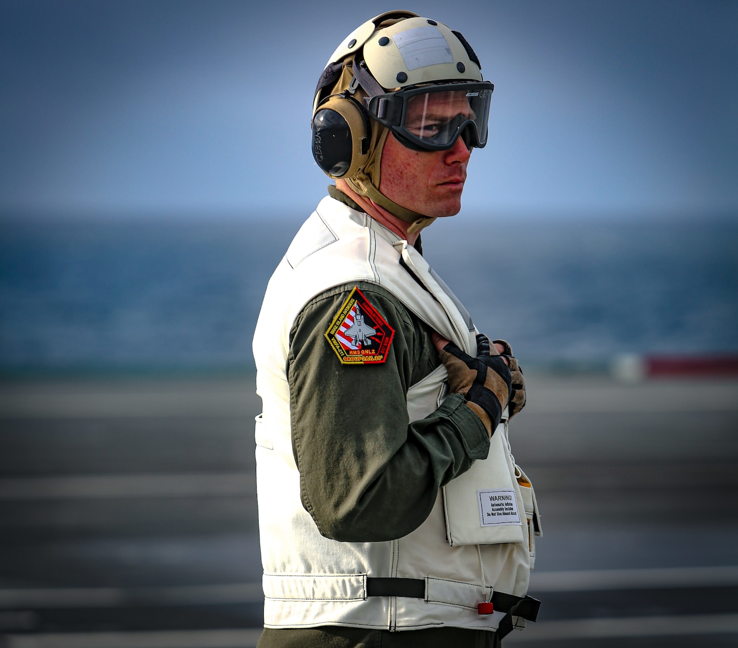 Maj Brian Kimmins with Marine Fighter Attack Squadron (VMFA) 211 observes pre-flight checks aboard Her Majesty's Ship (HMS) Queen Elizabeth at sea on 27 September, 2020. VMFA-211 is deployed aboard HMS Queen Elizabeth to conduct training with their United Kingdom counterparts in preparation for the UK's Carrier Strike Group deployment this spring. The U.S. Marine Corps is supporting this historic deployment in support of USMC, DoD, National and Allied objectives.