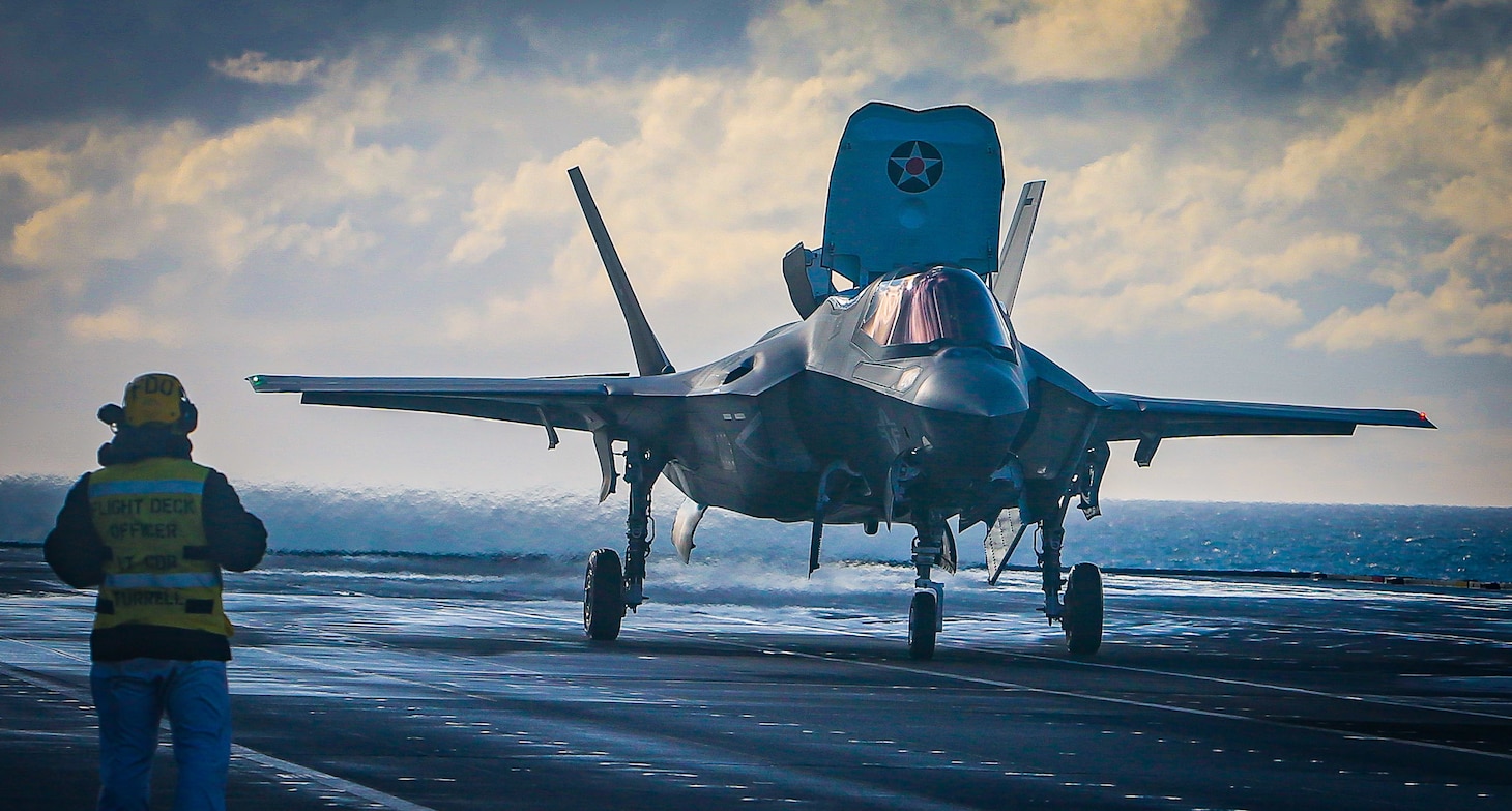 A Marine with Marine Fighter Attack Squadron (VMFA) 211 prepares to launch an F-35B Lightning II Joint Strike Fighter from the deck aboard Her Majesty's Ship (HMS) Queen Elizabeth at sea on 10 October, 2020. VMFA-211 is deployed aboard HMS Queen Elizabeth to conduct training with their United Kingdom counterparts in preparation for the UK's Carrier Strike Group deployment this spring. The U.S. Marine Corps is supporting this historic deployment in support of USMC, DoD, National and Allied objectives.