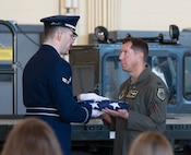 U.S. Air Force Toby Rivas, 5th Operations Support Staff operations intelligence analyst (left), performs flag folding for a retirement ceremony at Minot Air Force Base, North Dakota, June 28, 2024. Members of the Honor Guard perform their ceremonial duties in addition to their primary Air Force specialty. (U.S. Air Force photo by Airman 1st Class Luis Gomez)