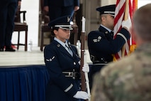 U.S. Air Force Airman Marianna Alcauter, 5th Logistics Readiness Squadron fuels distribution operator (left), presents the colors during a retirement ceremony at Minot Air Force Base, North Dakota, July 3, 2024. The Minot AFB Honor Guard serves a distinct mission under unique conditions from performing military honors North Dakota to presenting colors on base. (U.S. Air Force photo by Airman 1st Class Luis Gomez)