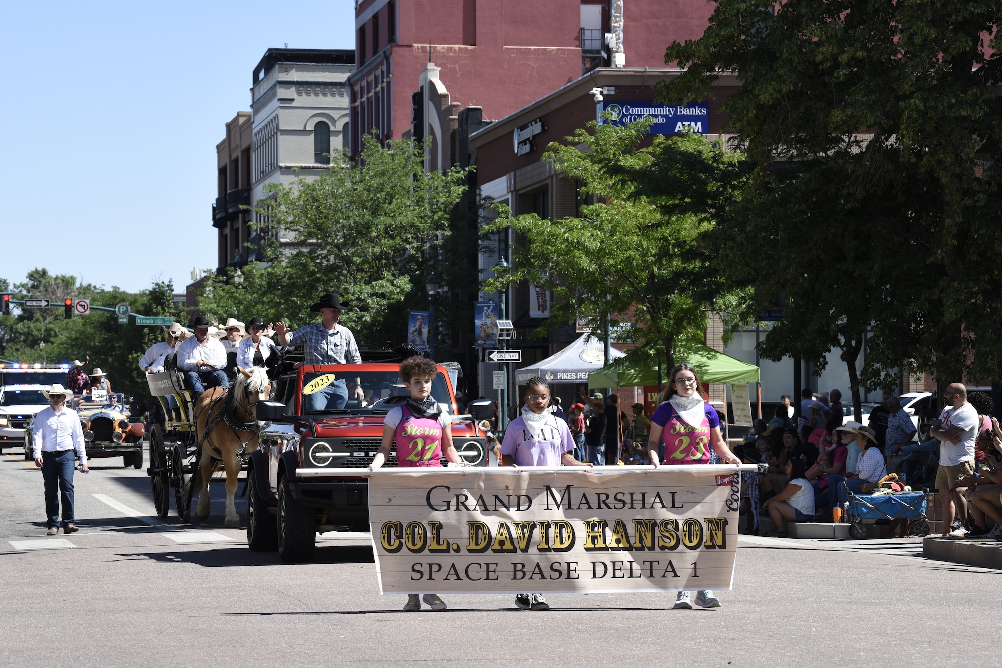U.S. Space Force Col. David Hanson, Space Base Delta 1 commander, waves to the crowd as the grand marshal during the 81st Annual Pikes Peak or Bust Rodeo Parade in Colorado Springs, Colorado, July 6, 2024. The parade marks the beginning of the Pikes Peak or Bust Rodeo, a community tradition since 1936. The event celebrates Western culture and donates proceeds to help support quality of life initiatives for active-duty military families in the area. (U.S. Space Force photo by Connie Dillon)