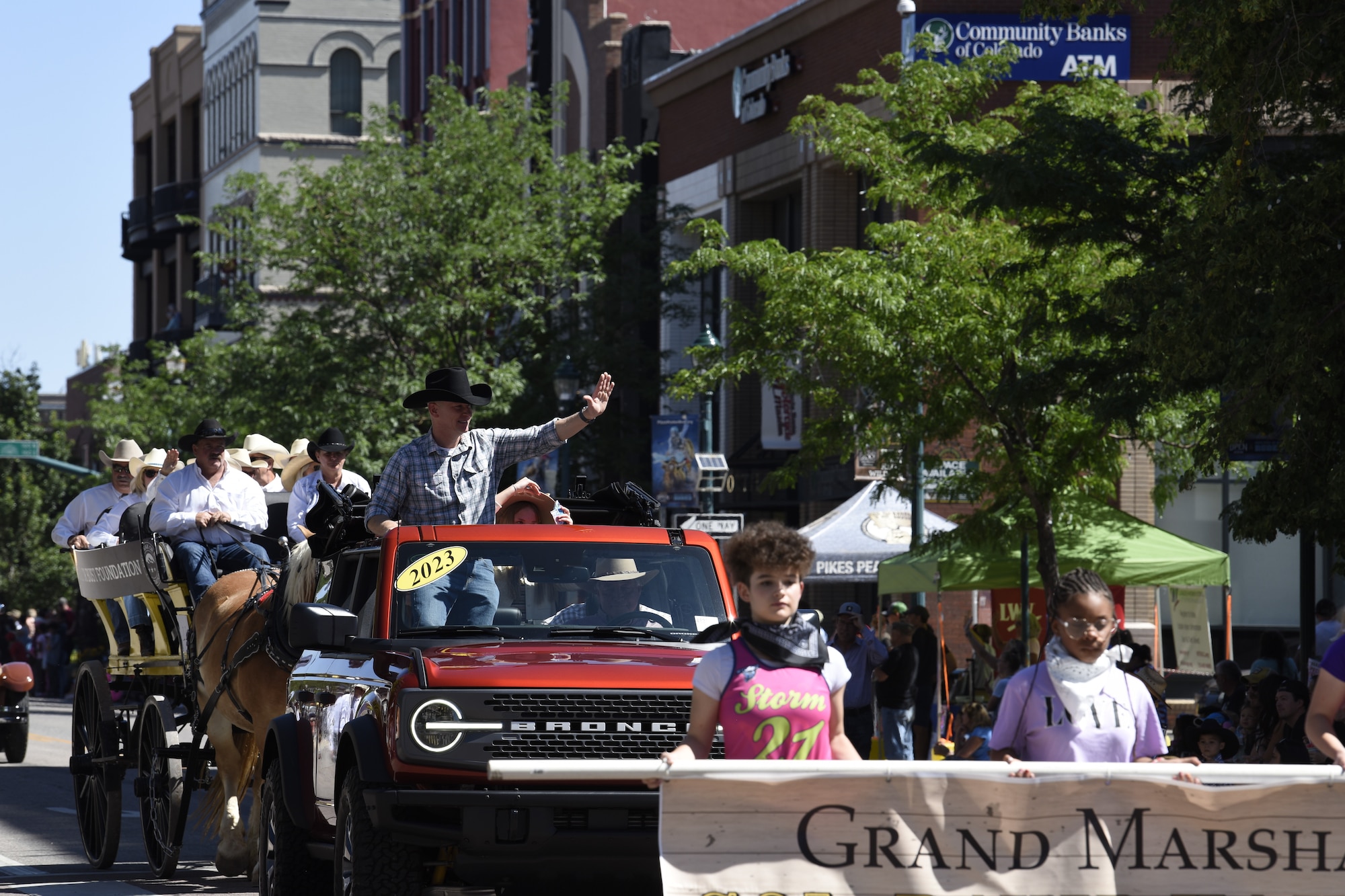 U.S. Space Force Col. David Hanson, Space Base Delta 1 commander, waves to the crowd as the grand marshal during the 81st Annual Pikes Peak or Bust Rodeo Parade in Colorado Springs, Colorado, July 6, 2024. The parade marks the beginning of the Pikes Peak or Bust Rodeo, a community tradition since 1936. The event celebrates Western culture and donates proceeds to help support quality of life initiatives for active-duty military families in the area. (U.S. Space Force photo by Connie Dillon)