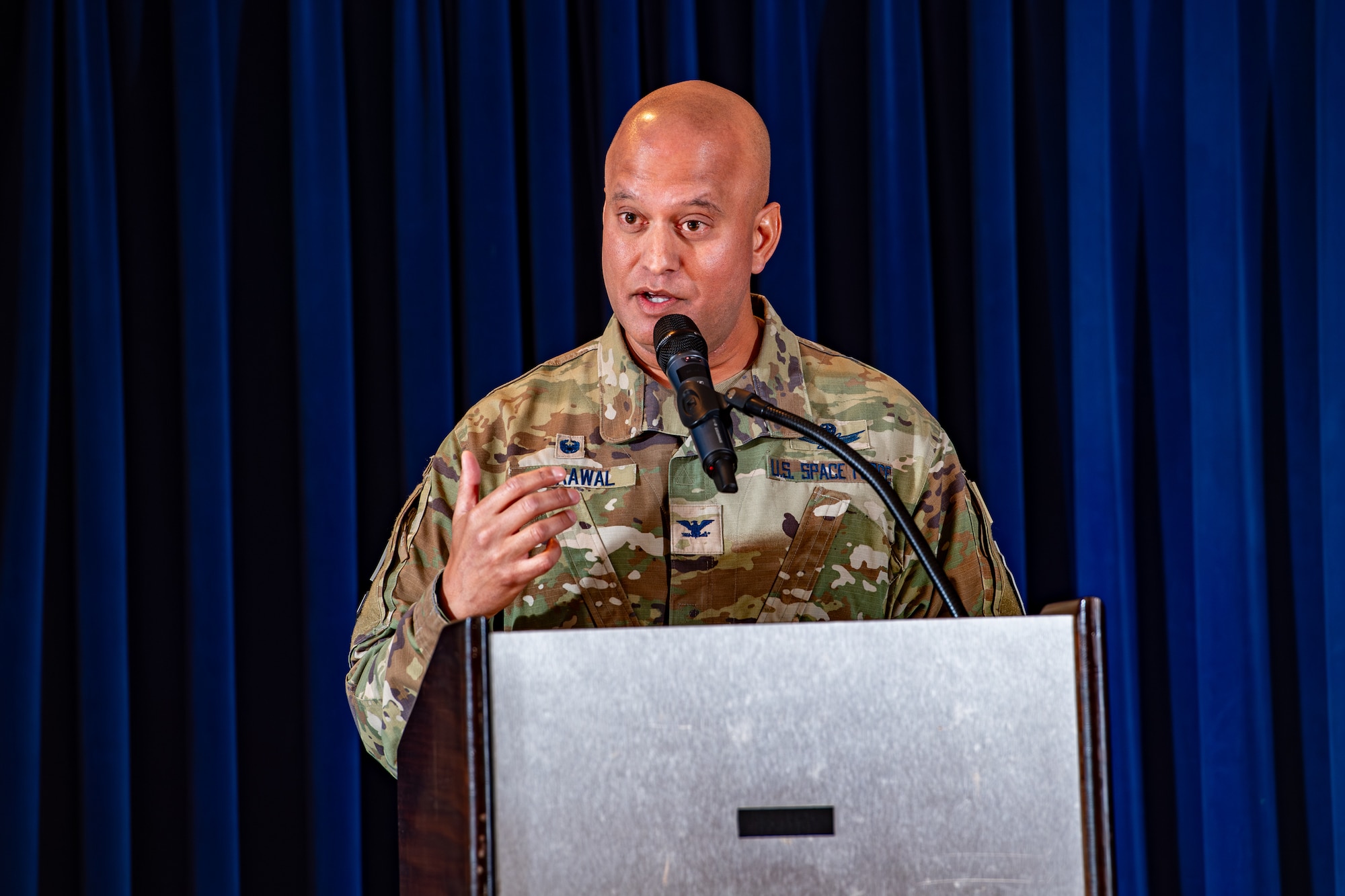 Man in military uniform speaks at podium