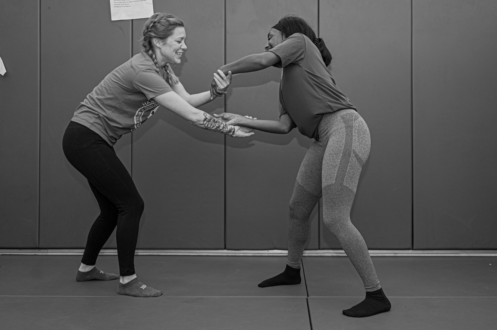 Photo of two participants practicing controlling techniques. Photo in black and white.