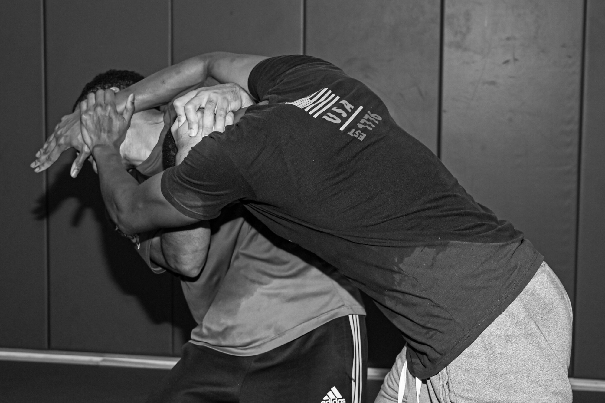 Photo of two Airmen grappling in black and white.