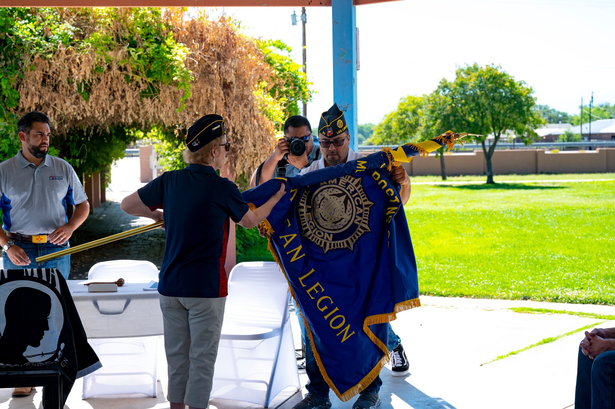 Woman rolls up flag.