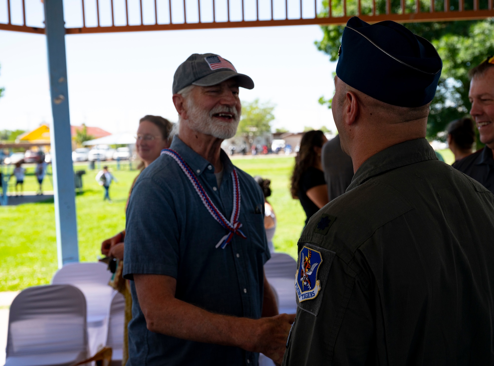 Man shakes another mans hand.