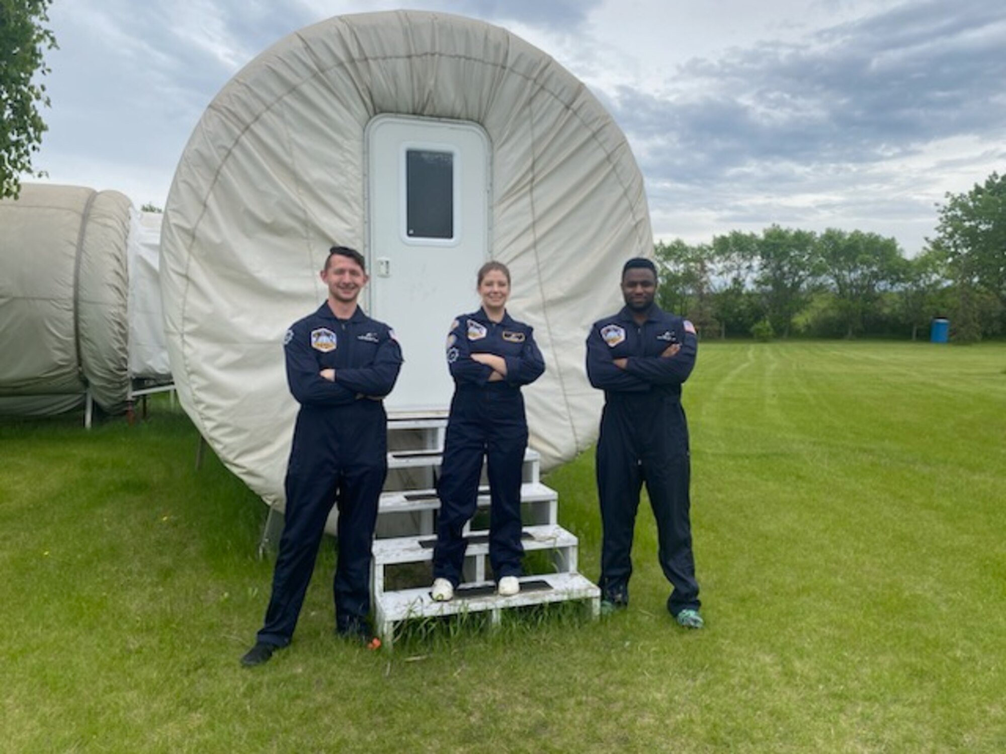 Wallace and his crew stand outside the habitat to pose for a photo.