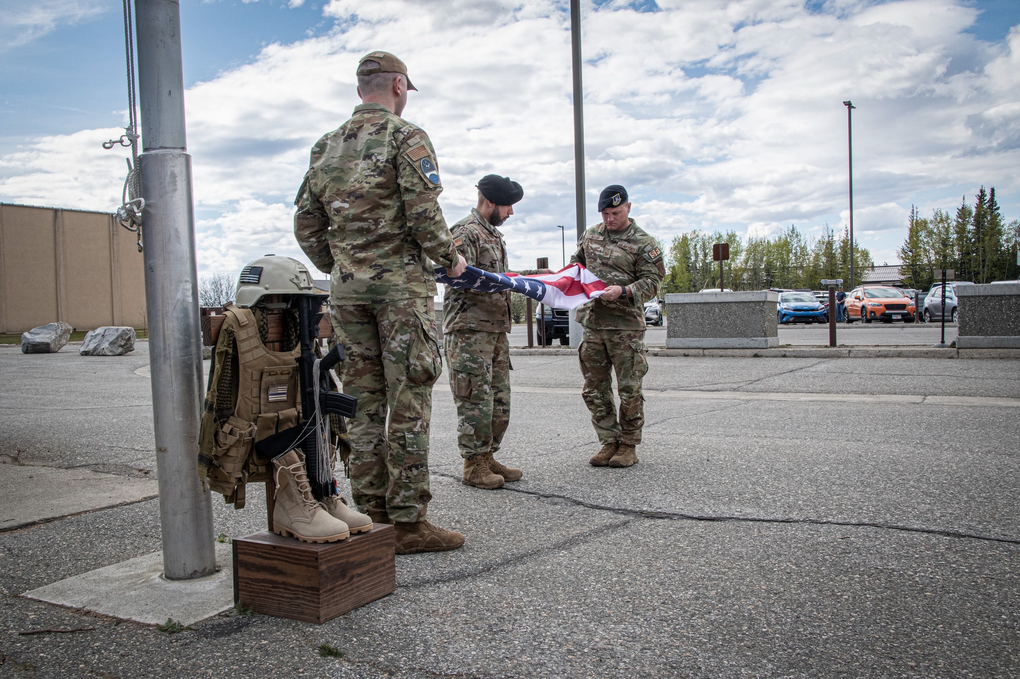 Master Sgt. Joshua Marugg, 268th Security Forces, right, Tech Sgt. Luis Maldonado, 268th Security Forces, center, and Staff Sgt. Timothy Jones, Chaplain Affairs, Maine Air National Guard, left, fold the American flag during the Final Roll ceremony held at Clear Space Force Station, Alaska.
