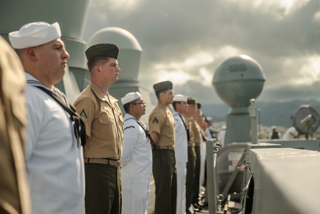 U.S. Marines assigned to the 15th Marine Expeditionary Unit and Sailors assigned to the amphibious transport dock USS Somerset (LPD 25) man the rails as Somerset pulls into port for Exercise Rim of the Pacific (RIMPAC) 2024 at Joint Base Pearl Harbor-Hickam, Hawaii, July 3. Twenty-nine nations, 40 surface ships, three submarines, 14 national land forces, more than 150 aircraft, and 25,000 personnel are participating in RIMPAC in and around the Hawaiian Islands, June 27 to Aug. 1. The world's largest international maritime exercise, RIMPAC provides a unique training opportunity while fostering and sustaining cooperative relationships among participants critical to ensuring the safety of sea lanes and security on the world's oceans. RIMPAC 2024 is the 29th exercise in the series that began in 1971. (U.S. Marine Corps photo by Sgt. Patrick Katz)