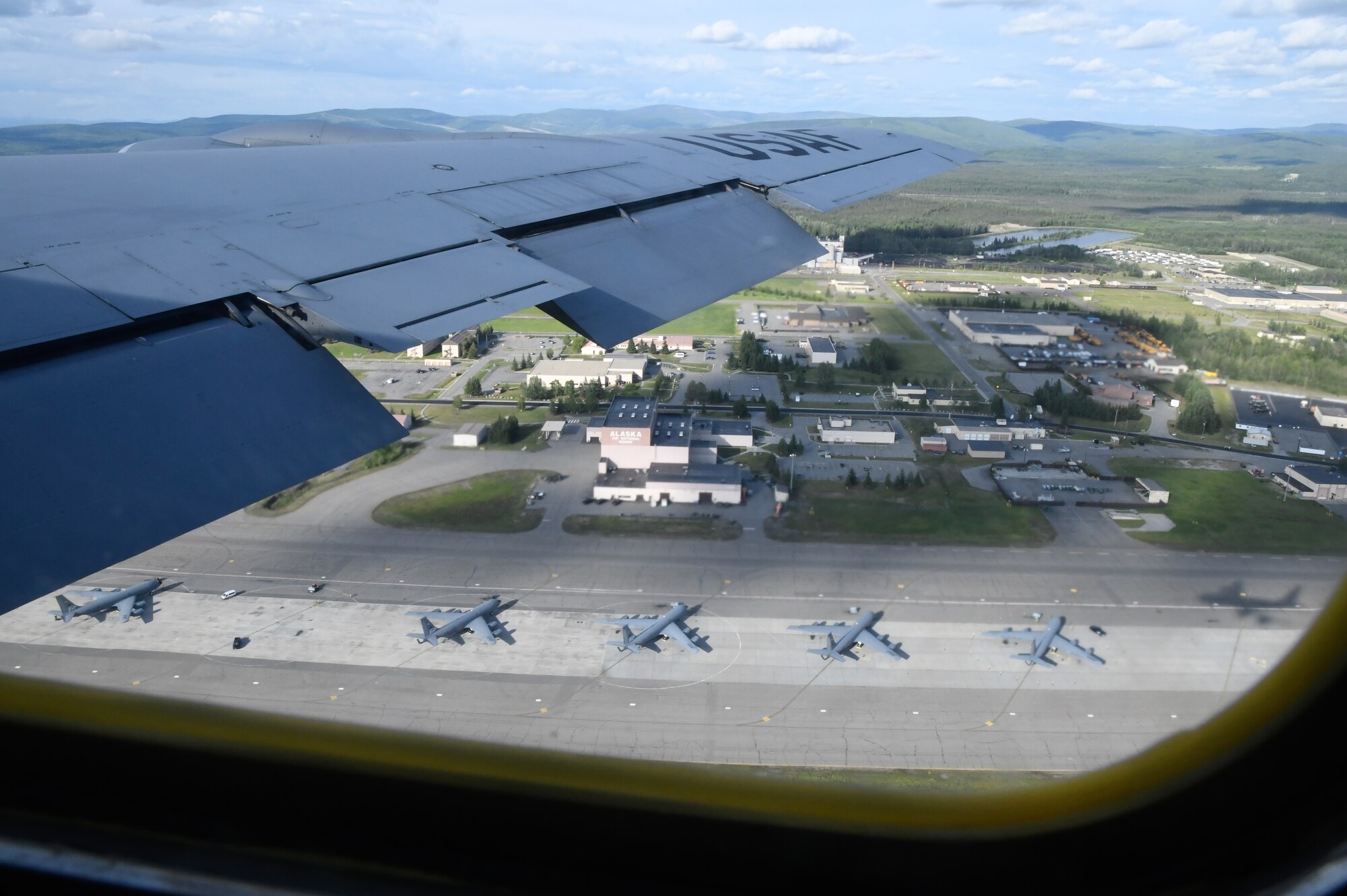 A KC-135 Stratotanker assigned to the 168th Wing, Alaska Air National Guard, flies over the 168 WG tanker row at Eielson Air Force Base after an aerial refueling mission during Red Flag Alaska 24-2.