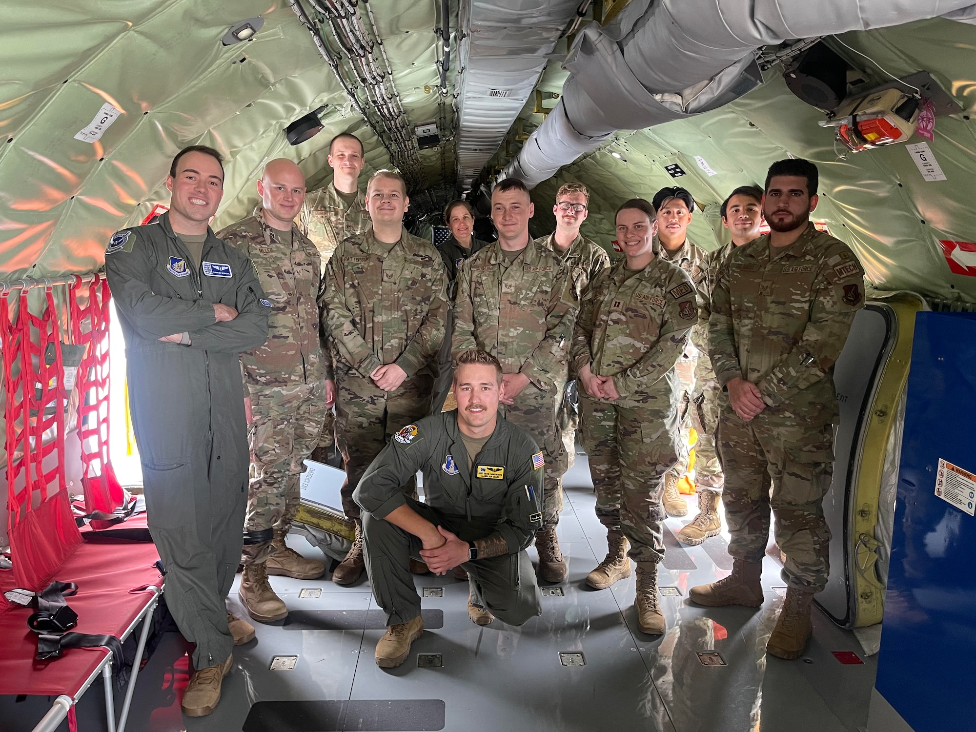 U.S. Air Force Staff Sgt. Devin Farnsworth, 168th Wing KC-135 boom operator, center, 25th Fighter Squadron, and 51st Fighter Squadron Maintenance Airmen, 355th Fighter Squadron flight doc, and the 354th physical therapist take a photo together on board a 168 WG KC-135 Stratotanker before taking flight for an aerial refueling mission
