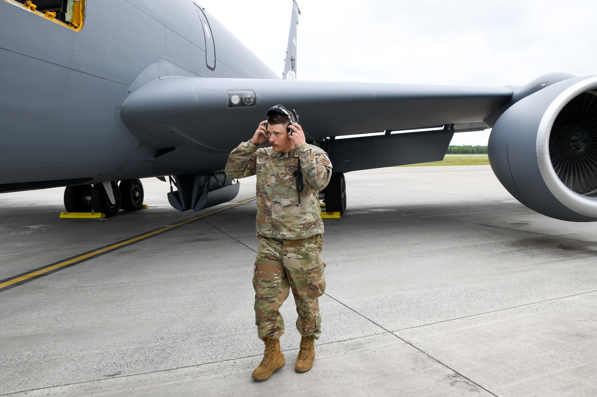 U.S. Air National Guard Staff Sgt. Jessy Gray, 168th Aircraft Maintenance crew chief, dawns his headset while finishing the preflight inspection and in preparation for sending the 168 WG Stratotanker on a mission during Red Flag Alaska.