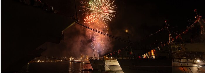 Arleigh Burke-class guided-missile destroyers USS Frank E. Petersen Jr. (DDG 121) and USS William P. Lawrence (DDG 110) are moored at Joint Base Pearl Harbor-Hickam, Hawaii, during the Independence Day fireworks display during Exercise Rim of the Pacific (RIMPAC) 2024.