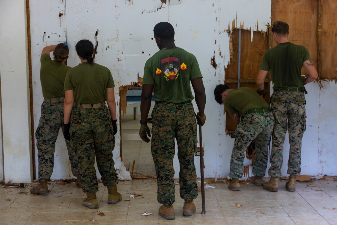 U.S. Marines with Combat Logistics Battalion 13, Combat Logistics Regiment 17, 1st Marine Logistics Group, execute the deconstruction phase of the Peleliu Civic Center restoration project on Peleliu, Republic of Palau, July 1, 2024, an effort c to commemorate the 80th anniversary of the Battle of Peleliu. Koa Moana’s deployment throughout the Indo-Pacific region, U.S. Marines and Sailors from I Marine Expeditionary Force, work to strengthen alliances and partnerships with development of interoperable capabilities, combined operations, theater security cooperation, and capacity-building efforts. Exercises like Koa Moana administer 1st MLG to tackle complex challenges by fostering collaboration among bold thinkers and employing creative methods to optimize prepositioning, enhance sustainment and distribution networks, and bolster readiness in distributed environments such as Palau, the Federal States of Micronesia, and Papua New Guinea. (U.S. Marine Corps photo by Cpl. Brandon Marrero)